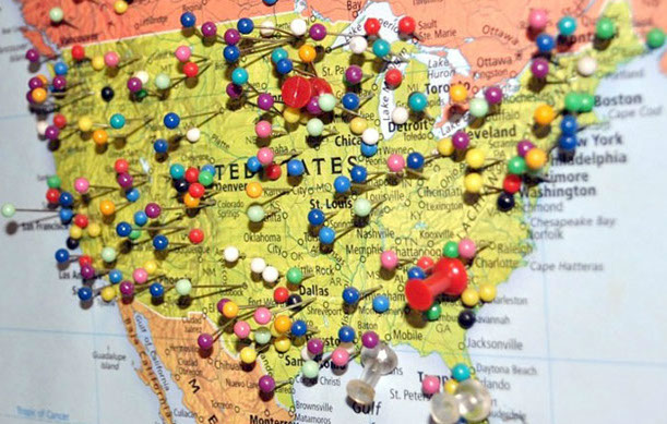 A map of the United States with push pins stuck in it depicting places someone has traveled or been to.